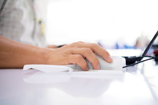 Coronavirus COVID-19 sanitize disinfecting wipes cleaning disinfection of work mouse. Wiping with antibacterial wipe the surface of desk, keyboard, at office against corona virus COVID-19. photo