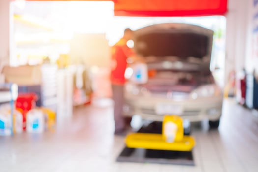 car service blurred, repair, maintenance concept - Asian auto mechanic man, technician doing the checklist for repair machine a car in the garage photo