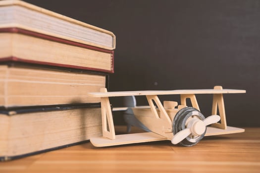 Airplane model on old educational book in library for history education and commemoration for Wright Brothers day, International civil aviation day photo
