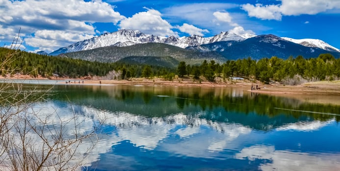 Panorama Snow-capped and forested mountains near a mountain lake, Pikes Peak Mountains in Colorado Spring, Colorado, US photo