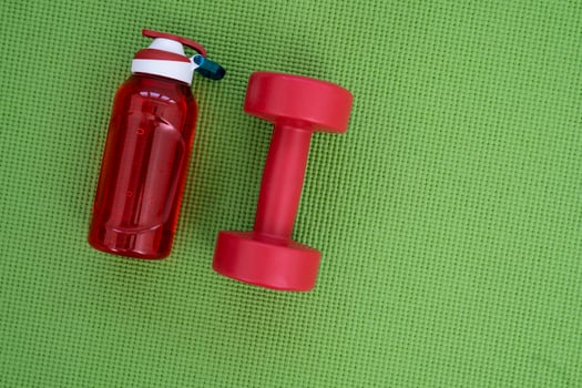 Banner of sport and fitness equipment, water bottle on green yoga mat photo
