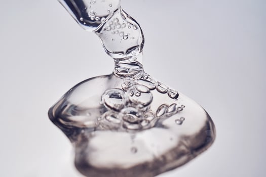 Pipette with cosmetic gel or serum close-up. photo