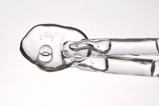 Pipette with cosmetic gel or serum close-up. photo