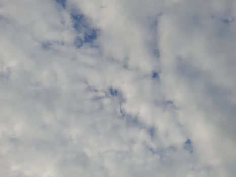 Beautiful white clouds on deep blue sky background. Large bright soft fluffy clouds are cover the entire blue sky. photo