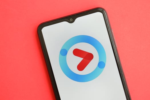 KYIV, UKRAINE - APRIL 1, 2024 Youku icon on smartphone screen on red table photo