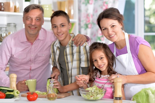 Portrait of beautiful family cooking at kitchen photo