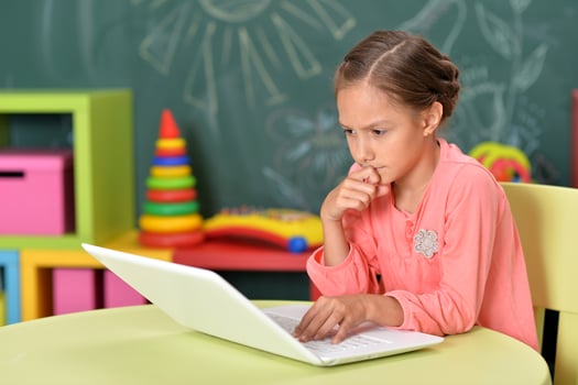 Portrait of girl studing with laptop at classroom photo