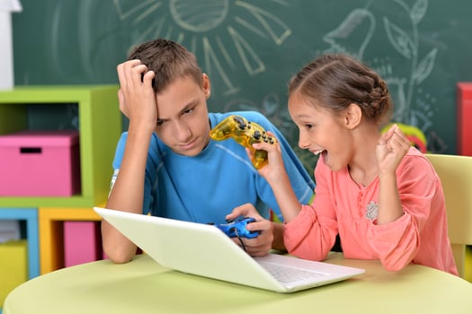 Portrait of brother and sister using laptop photo