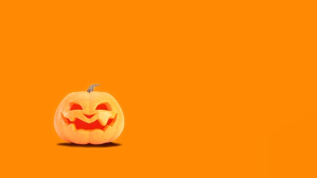 Halloween pumpkin smiles on orange background with copyspace.Funny Jack o lantern Halloween backdrop photo