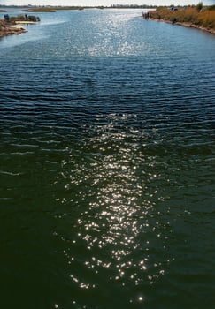Reflection of the sun and glare in the water of the Tiligul estuary canal, Ukraine photo