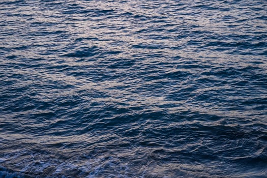 small waves on the Mediterranean sea during sunset photo