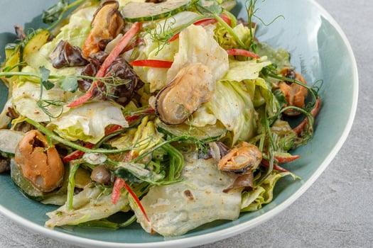 salad with mussels and tree mushroom on a stone background studio food photo 3
