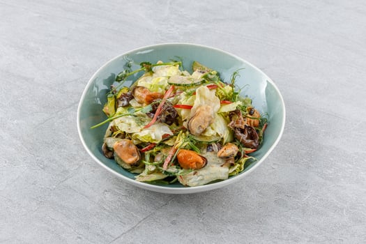 salad with mussels and tree mushroom on a stone background studio food photo 2