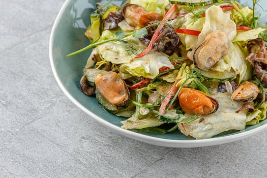 salad with mussels and tree mushroom on a stone background studio food photo 1