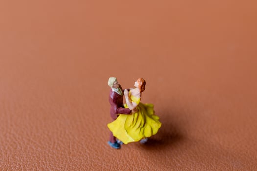 Couple dancing on a smooth brown background photo