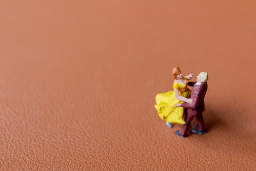 Couple dancing on a smooth brown background photo