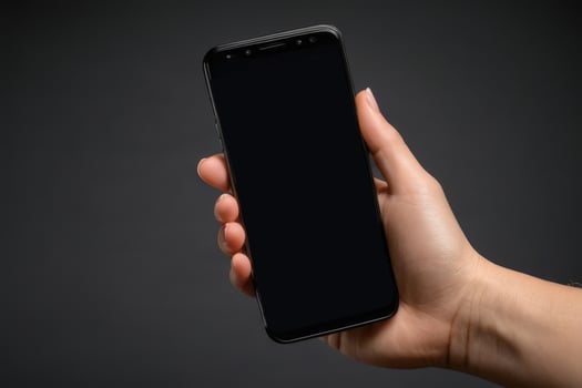 Close-up of a person's hand holding a smartphone photo