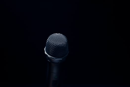 Black and silver microphones in the studio on a black and dark background. Professional recording equipment. Top view. photo