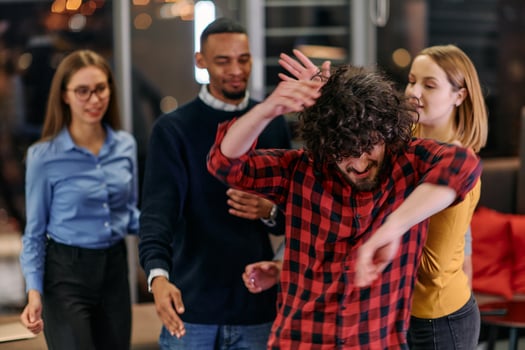 A group of young business people have fun playing interesting games while taking a break from work in a modern office. Selective focus photo