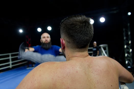 Cornered boxer receives strategic advice from trainer during intense bout. photo