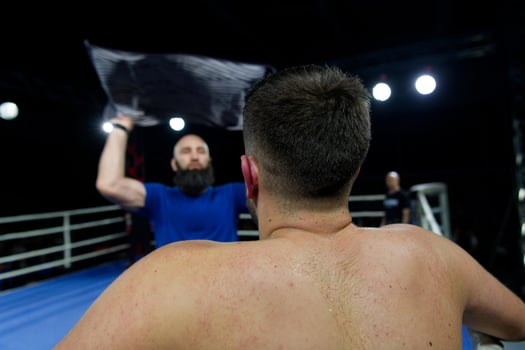 Cornered boxer receives strategic advice from trainer during intense bout. photo