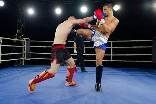 Kickboxing rivals unleash powerful leg strikes in a thrilling match. photo