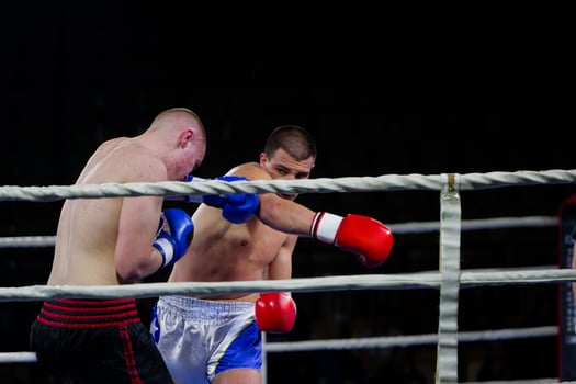 Fierce boxing match showcases athletes' power and skill. photo