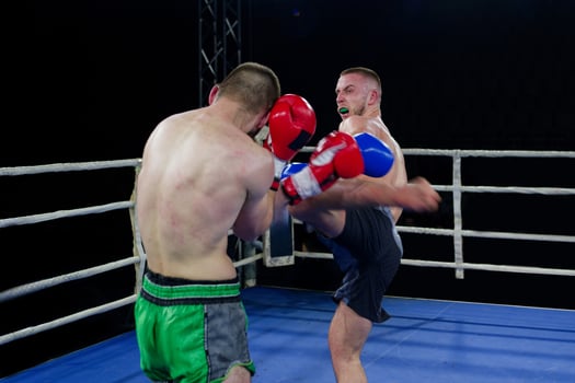 Kickboxing rivals unleash powerful leg strikes in a thrilling match. photo