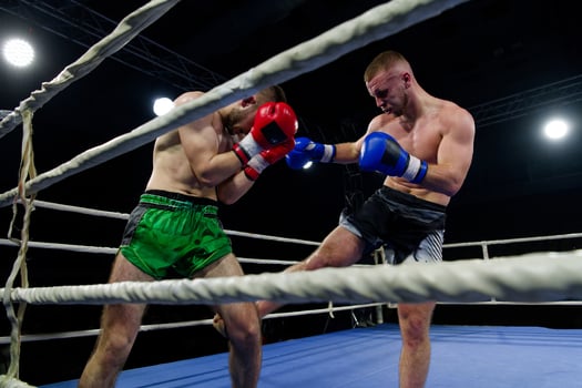 Kickboxing rivals unleash powerful leg strikes in a thrilling match. photo