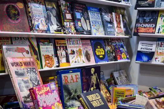 New Delhi, India, February 17 2024 - Variety of Books on shelf inside a book-stall at Delhi International Book Fair, Selection of books on display in Annual Book Fair at Bharat Mandapam complex photo