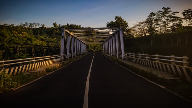 A bridge in the forest with blue sky photo