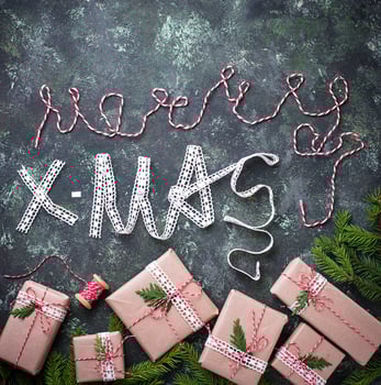 Gift box and text Merry Christmas from decorative ribbon photo