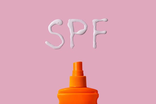 Sunscreen SPF cream on yellow background photo