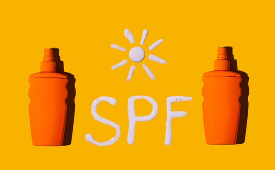 Sunscreen SPF sunblock cream on yellow background photo
