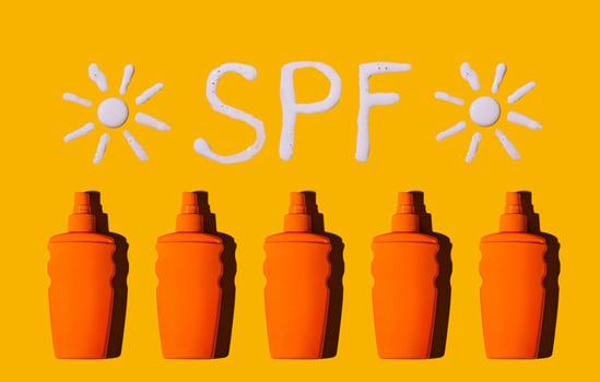 Sunscreen SPF sunblock cream on yellow background photo