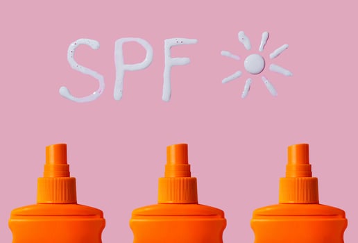 Sunscreen SPF sunblock cream on yellow background photo