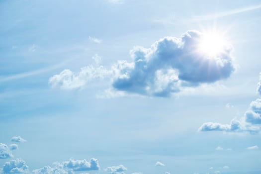 Sun in blue sky with cloud and the bright sun with rays and highlights photo