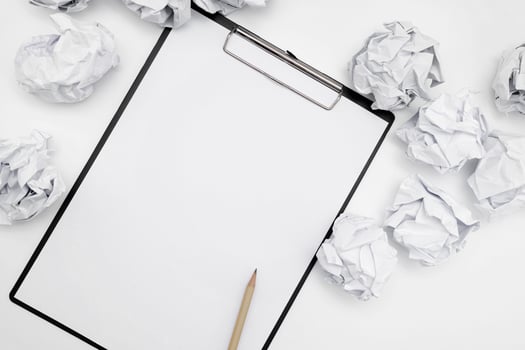 Total white monochromatic stationery flat lay. Notepad, white pencil and crumpled paper balls on white background. photo