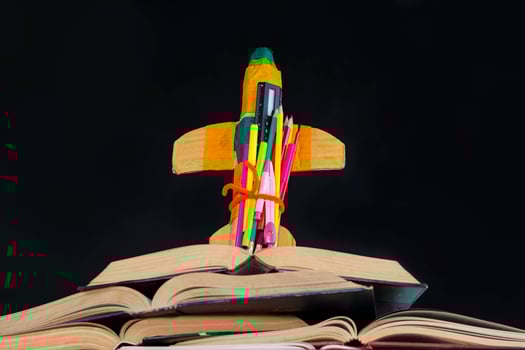 Creative Rocket With Colorful Pencils And Books On Desk photo
