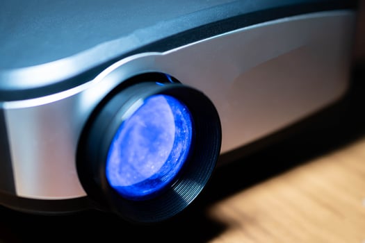 Close-up of modern projector lens with blue tint photo