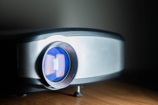 Modern digital projector with blue lens photo