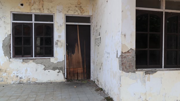 Old house, facade of a building ruin in old town photo