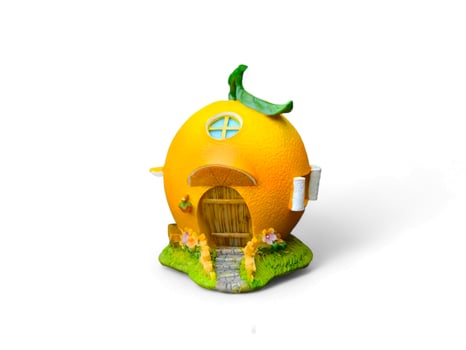 miniature house decoration in the shape of an orange on a white background photo