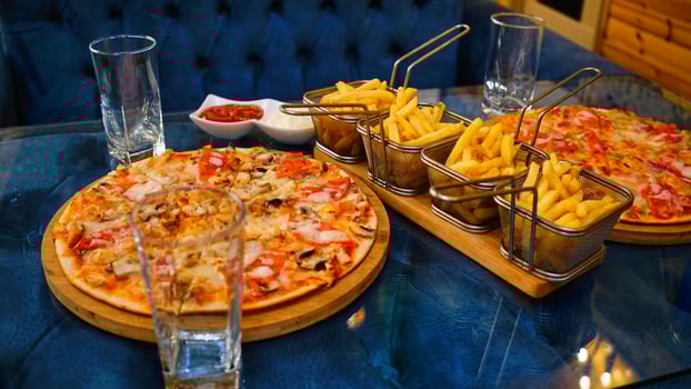 Pizza and French Fries on a Blue Tabletop photo
