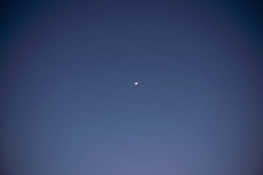 night blue sky and small crescent moon photo