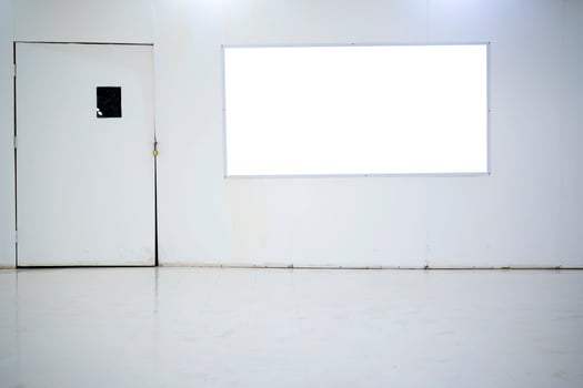 An empty billboard inside a shopping mall that is currently closed for renovations. photo