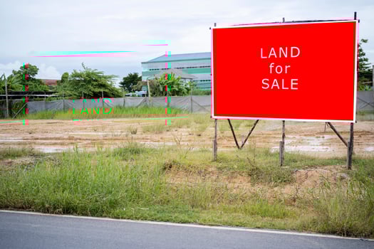A sign advertising agricultural land for industrial use for sale. photo