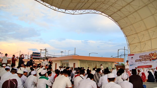 Muslim citizens gathering together to pray together photo