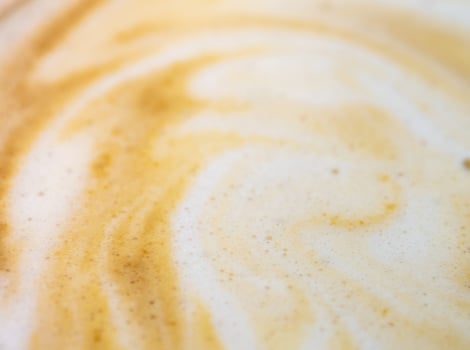 Texture surface of soft and delicate milk froth in a cup of coffee photo