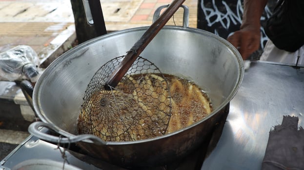 Street food seller in Indonesia selling fried food photo